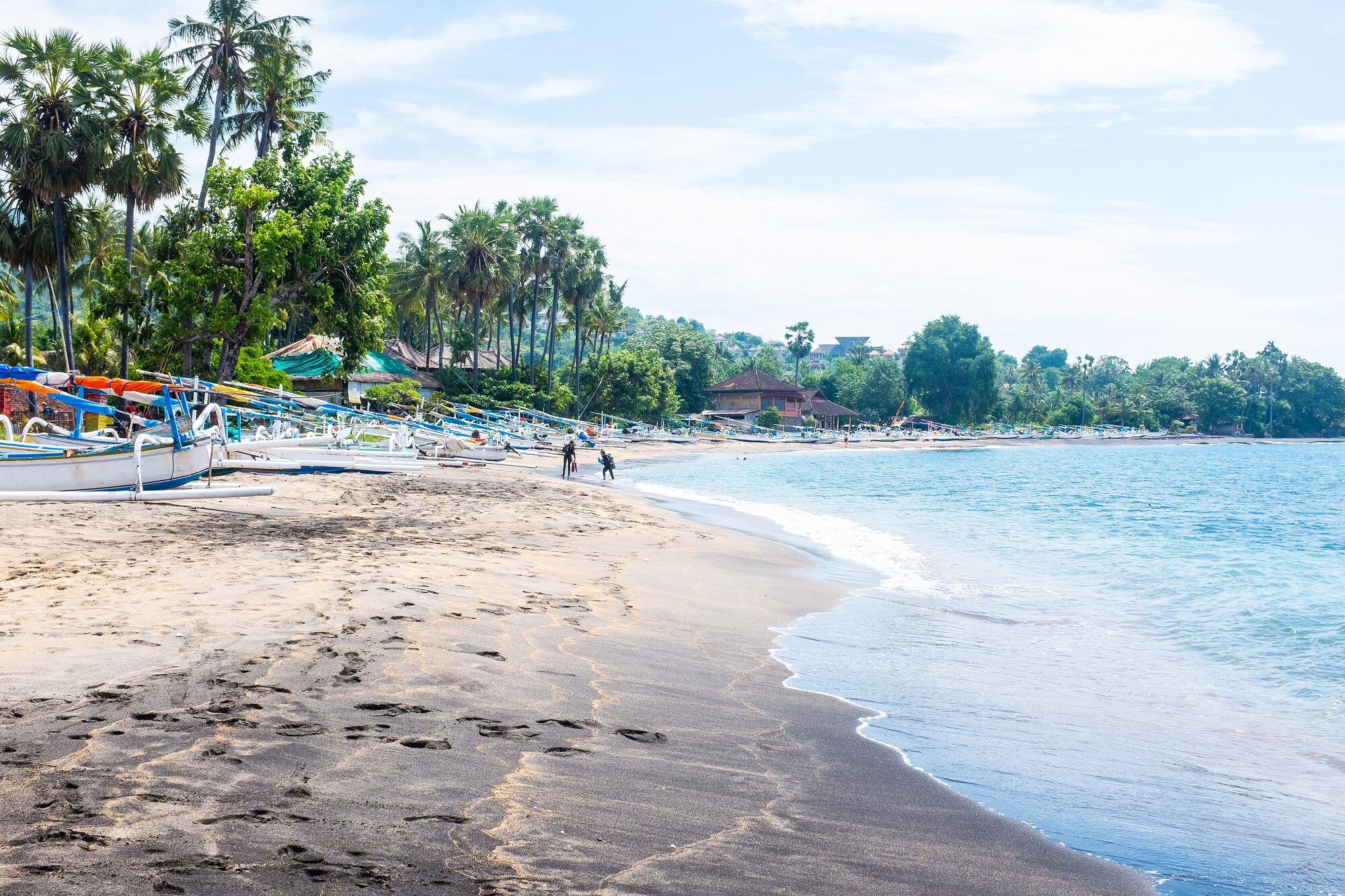 The beach at Amed with traditional outrigger boats on the sand