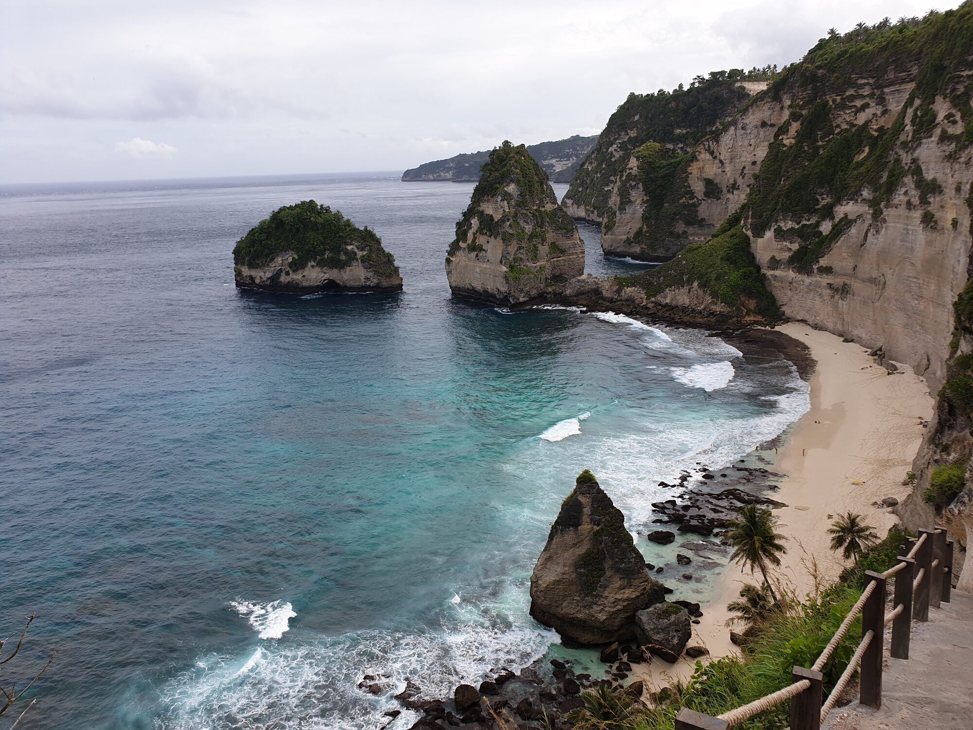 Diamond Beach on the east coast of Nusa Penida, white sand below limestone cliffs and rocks in the sea