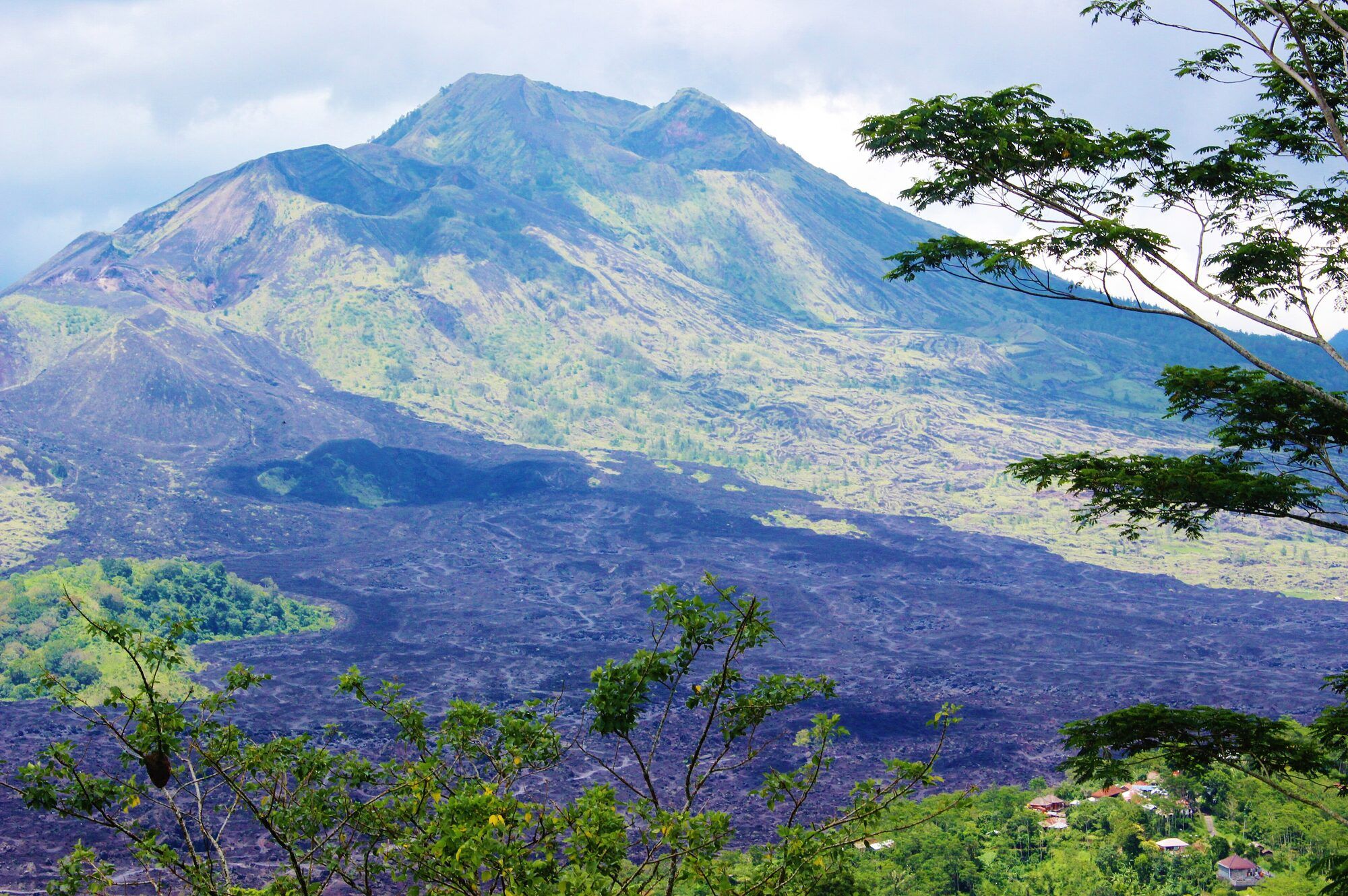 Mount Batur volcano with dark lava fields on its slopes